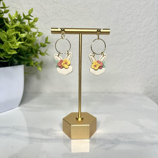 white bunny earrings with colored flowers on them